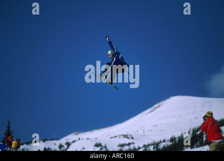 Snowboarder performing grab at big air competition in Canada Stock Photo