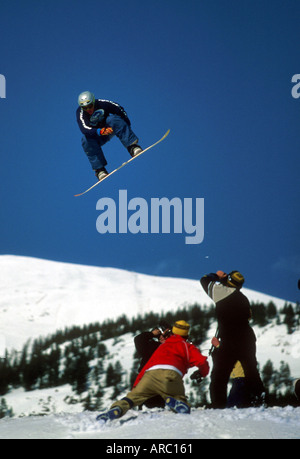 Snowboarder performing grab at big air competition in Canada Stock Photo