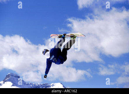 Snowboarder performing grab at big air competition in Canada Stock Photo