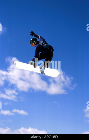 Snowboarder performing grab at big air competition in Canada Stock Photo