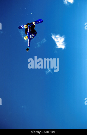 Snowboarder performing grab at big air competition in Canada Stock Photo