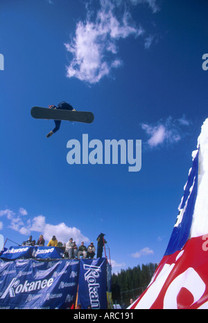 Snowboarder performing grab at big air competition in Canada Stock Photo