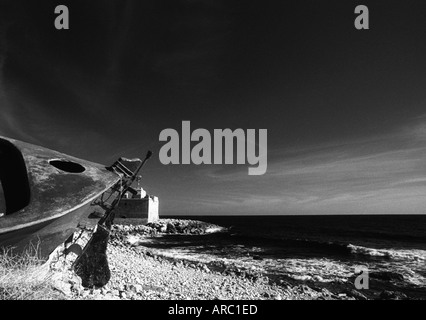 Romantic Paphos. Traditional fishing boat in dry storage on a pebbly beach, pointing seaward Stock Photo