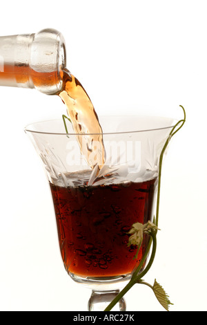 Red wine pouring down from a wine bottle Stock Photo