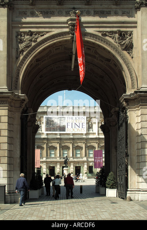 London Royal Academy archway entrance framing Burlington House and courtyard Piccadilly with various banners Stock Photo