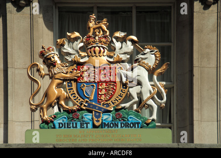Fortnum & and Mason close up of Royal Warrant crest above entrance in Piccadilly awarded to this large upmarket retail food store business London UK Stock Photo