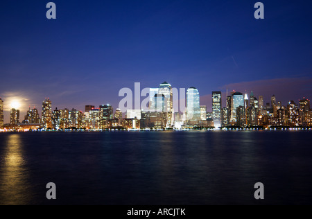 Full moon rising over Lower Manhattan skyline across the Hudson River, New York City, New York, USA, North America Stock Photo