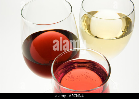 A glass each of red white and rose wine on a white background Stock Photo