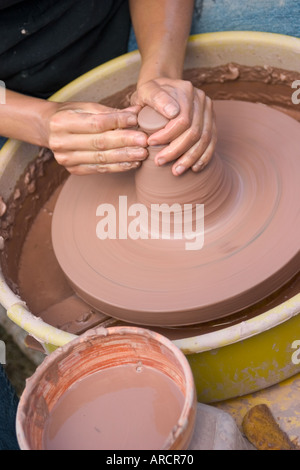 Young woman making a bowl on a potter's wheel Stock Photo