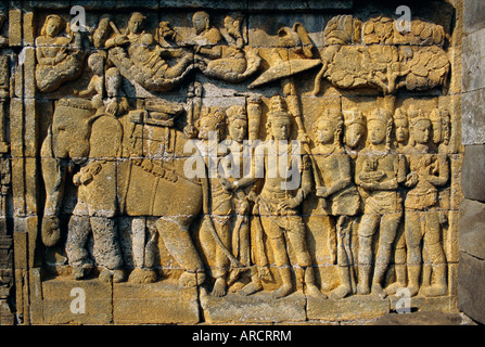 Relief carvings on frieze on outside wall of the Buddhist temple, Borobodur (Borobudur), Java, Indonesia Stock Photo