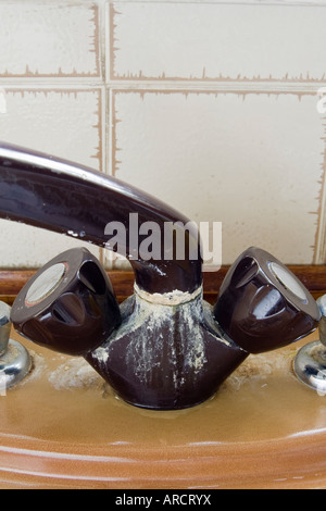 The old tap on the kitchen mixer is leaking. Tap water dripping