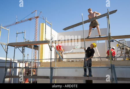 Scaffolders at work on a prefabricated house construction site Stock Photo