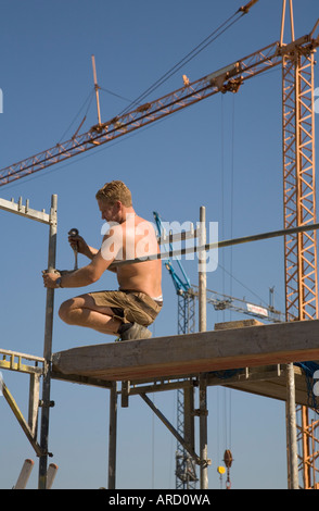 A scaffolder at work on a construction site Stock Photo