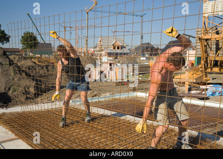 Building labourers at work on a construction site Stock Photo