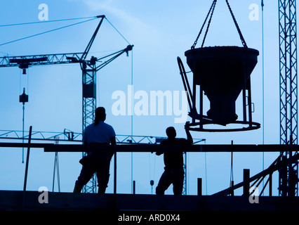 Building labourers at work on a construction site Stock Photo