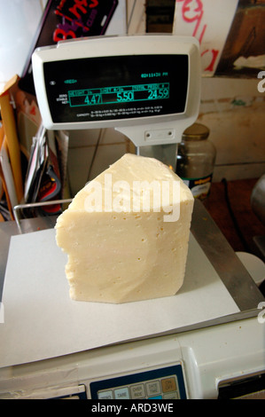 Cheese being weighed at Mike s Deli on Arthur Avenue in the Belmont section of the Bronx Stock Photo