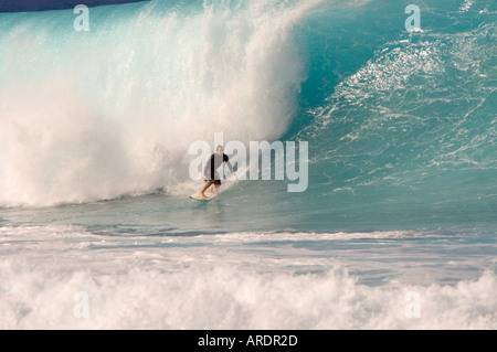 Surfer on classic big barreling surfing wave at Banzai Pipeline Rip Curl contest on the North Shore of Oahu Hawaiian Islands Stock Photo