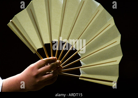 An official holds a fan at the Ryogoku stadium in Tokyo Japan Stock Photo