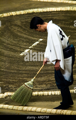 An official sweeps the sumo wrestling ring at the Ryogoku stadium in Tokyo Japan Stock Photo