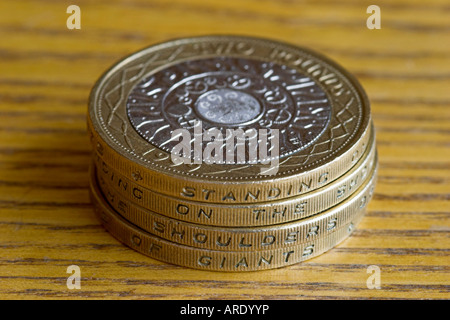 Four UK two pound coins.  Showing the inscription on the edge: Standing on the shoulders of giants.
