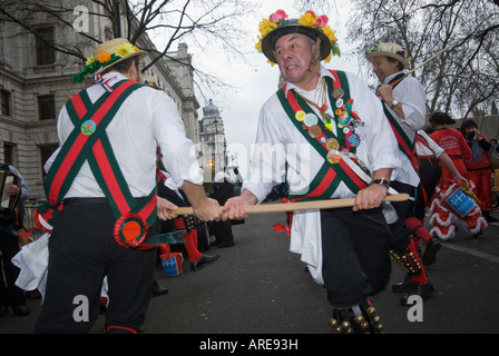 Male Morris Dancers perform sword dance on street in Parliament Square during London New Year Parade, 2008. Stock Photo