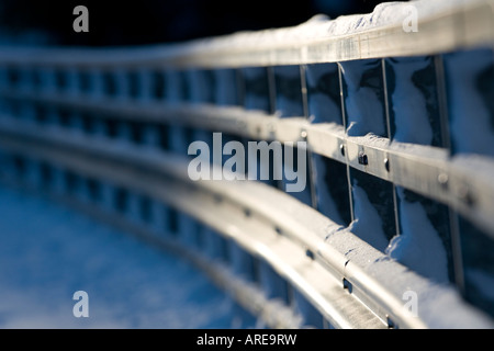 Closeup of a metallic snowy road bridge railing at Winter , Finland Stock Photo