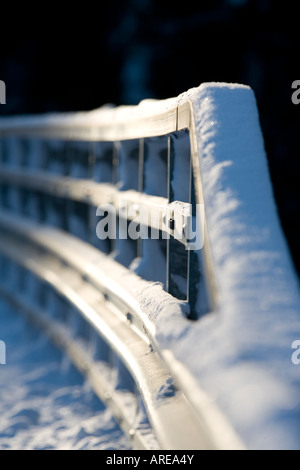 Closeup of a metallic snowy road bridge railing at Winter , Finland Stock Photo