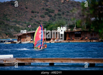 BVI Virgin Gorda North Sound windsurfer Pirate s Pub in background Stock Photo