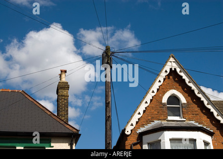 Telephone wires attached to wooden post in residential street London England UK Stock Photo