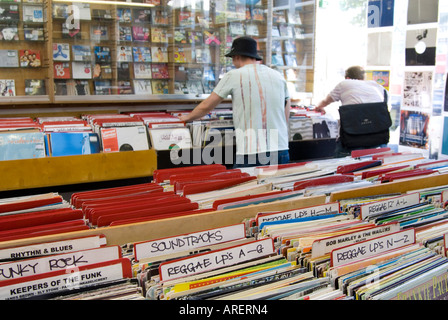 Young people browsing through music vinyl records in shop in Notting Hill, London England UK Stock Photo