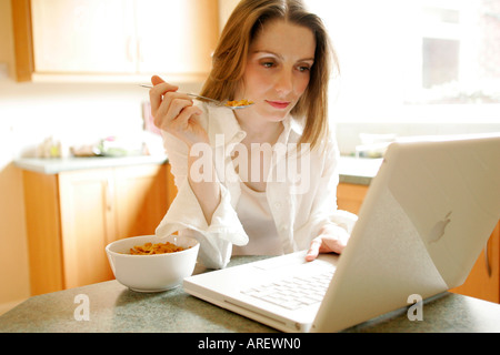 Woman using laptop computer at home Stock Photo