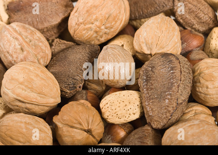 Various kinds of nuts in shells food from above overhead nobody full background  hi-res Stock Photo