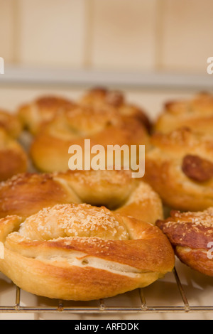 Warm home-made pretzels, fresh from the oven, lay cooling on cooling rack. Stock Photo