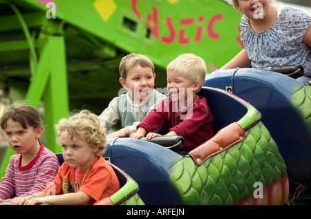 Young Children on Mini Roller Coaster Stock Photo