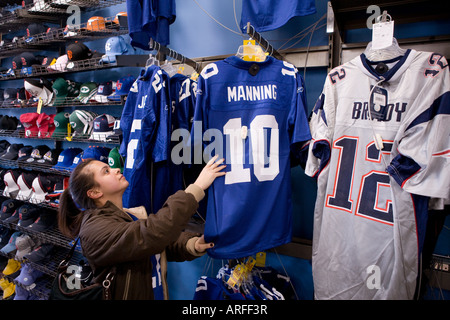 A woman shops for Football jerseys prior to the XLII Superbowl in 2008 between the New York Giants and the New England Patriots Stock Photo