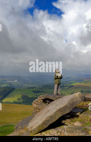 Female walker stood on 'Stanage edge'  viewing towards 'Hope Valley'  in Derbyshire 'Great Britain' Stock Photo