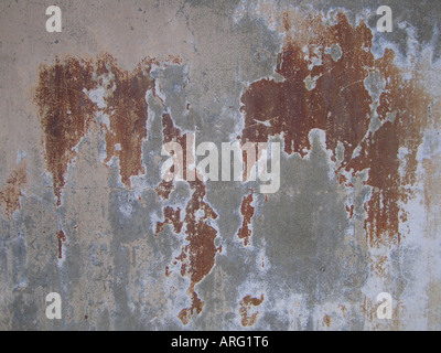 Worn concrete wall with rust colour showing Stock Photo