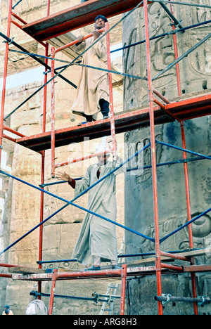 Karnak Egypt, Egyptian Construction Workers In Traditional Dress Setting Up Scaffolding for Renovating Temple 'Construction Site Stock Photo