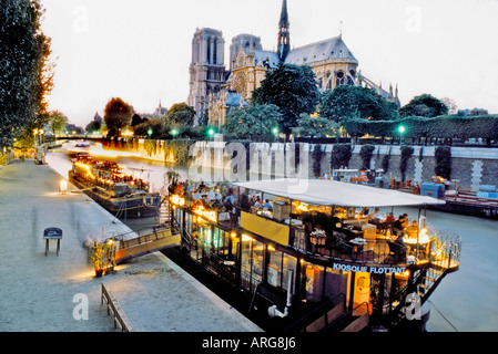 Paris France, Moored Peniche Boat French Bistro Restaurant on Seine River with Notre Dame Cathedral, 'The Kiosque' BOAT SEINE PARIS Stock Photo