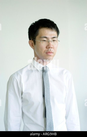 Portrait "young Asian Man""Businessman Looking Down" in White Shirt and Tie in "Medium Shot" Stock Photo