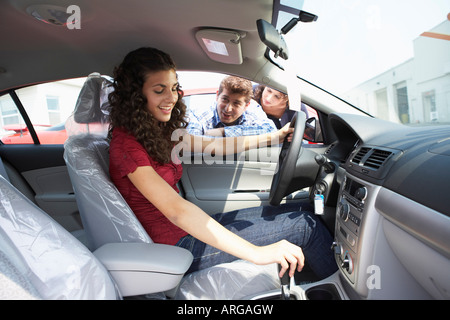 Teenager and Family Shopping For New Car