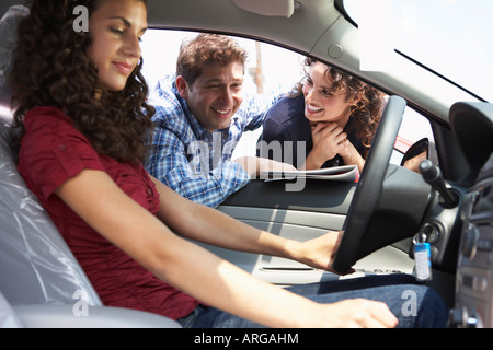 Teenager and Family Shopping For New Car