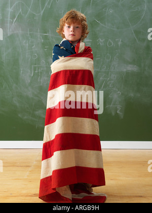 Boy Wrapped in the American Flag Stock Photo