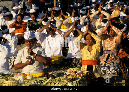 Kuta Beach, Ceremony Bali funereal cremation Balinese funeral procession, faith offering, Hindu universe, crowd, group, people, men, women, Indonesia, Stock Photo