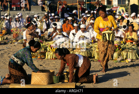 Kuta Beach, Ceremony Bali funereal cremation Balinese funeral procession, faith offering, Hindu universe, crowd, group, people, men, women, Indonesia, Stock Photo