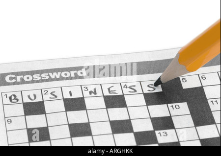 Business written on a crossword with a yellow pencil Stock Photo