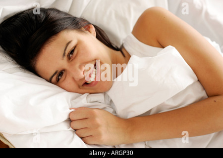 Brunette girl in bed Stock Photo