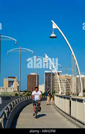 Man riding a bicycle on the bridge, Provencher Bridge, Winnipeg, Manitoba, Canada Stock Photo
