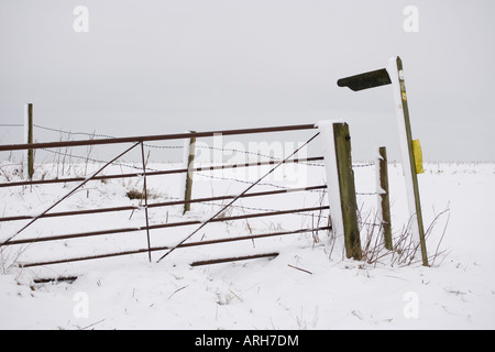 Gate and footpath sign in snow Stock Photo