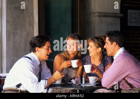 Two young couples age 20s having coffee in cafe Stock Photo